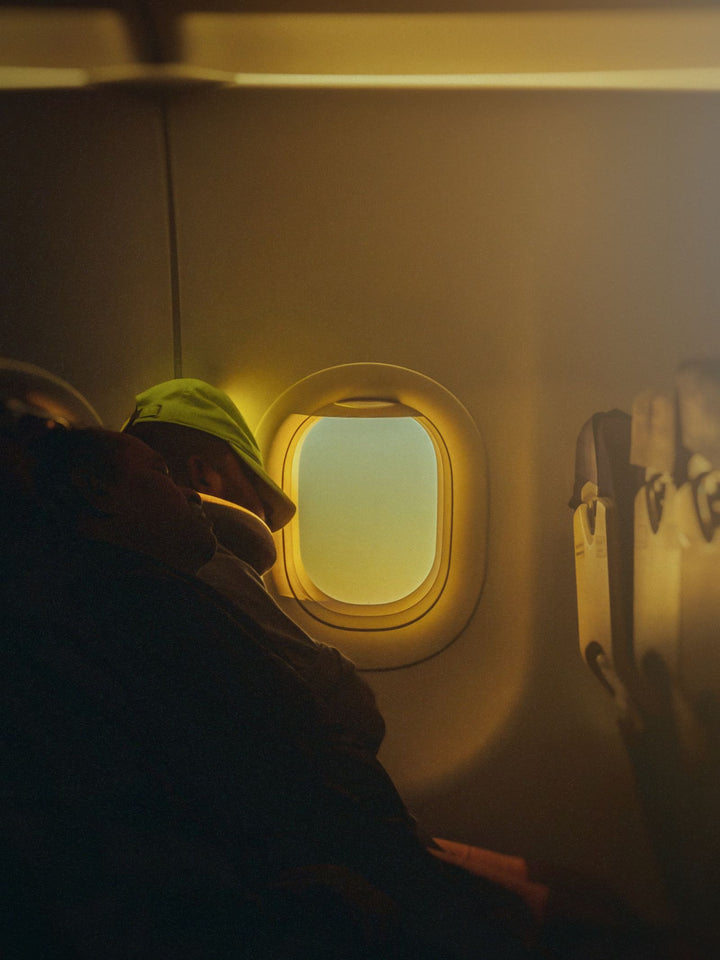 Passenger resting by the airplane window